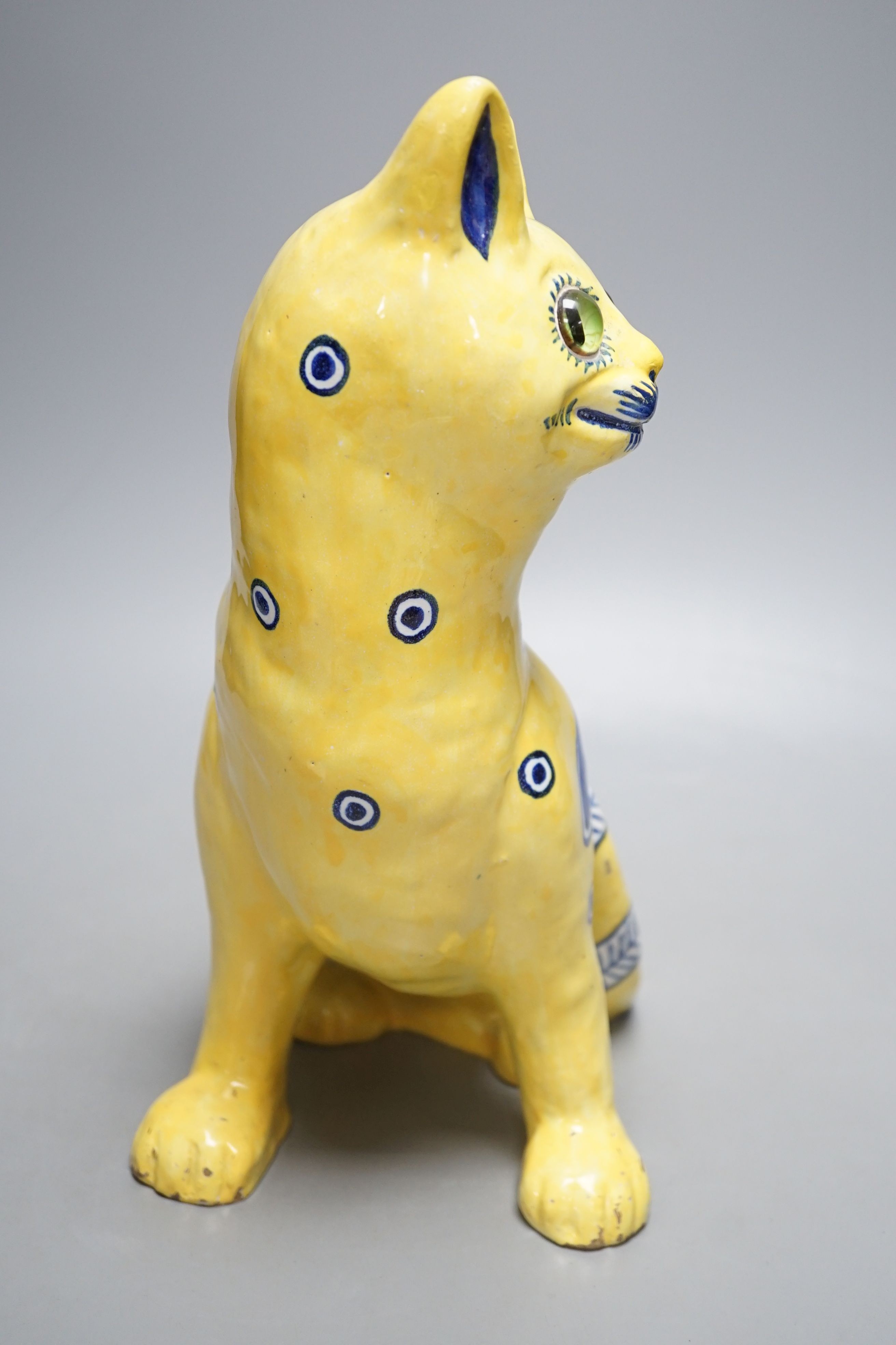 A Mosanic Galle style seated yellow and blue faience cat - 31cm tall